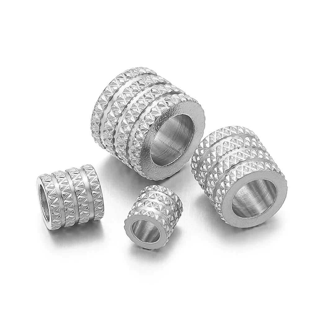 Silver-tone large-hole spacer beads with textured diamond pattern and central hole