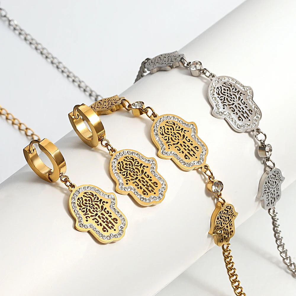 Gold- and silver-tone hamsa jewelry pieces with filigree charms and crystal borders