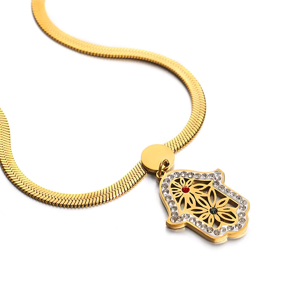Gold-tone mesh necklace with a crystal-edged hamsa pendant and floral filigree