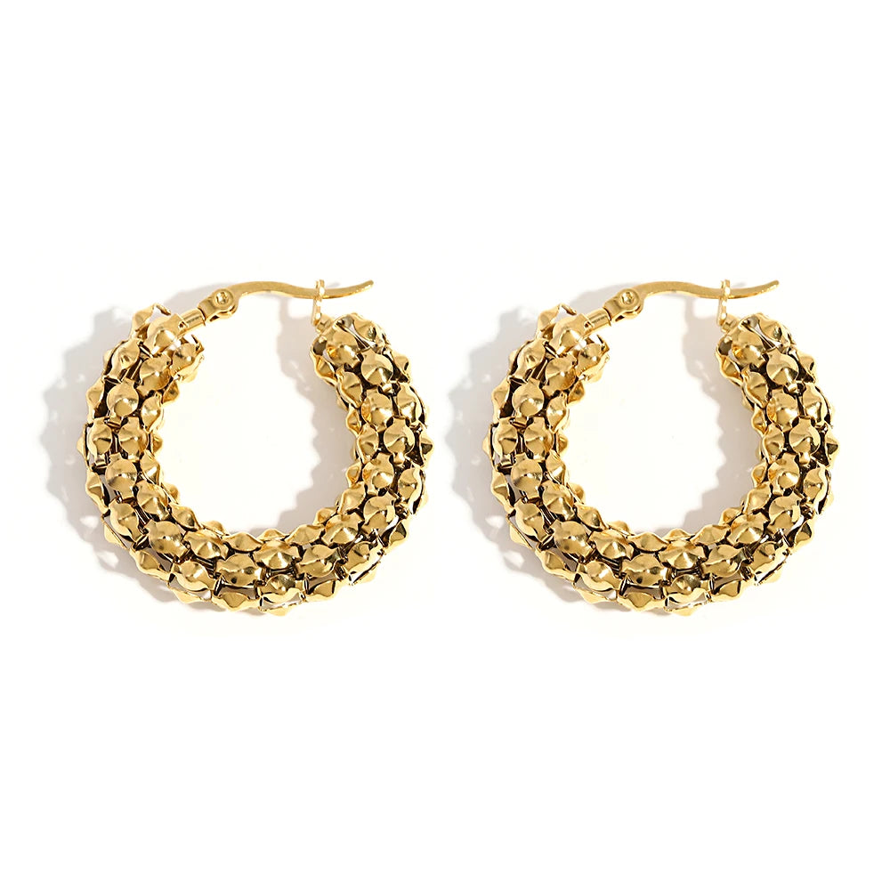 Gold-tone hoop earrings with densely textured, faceted surfaces