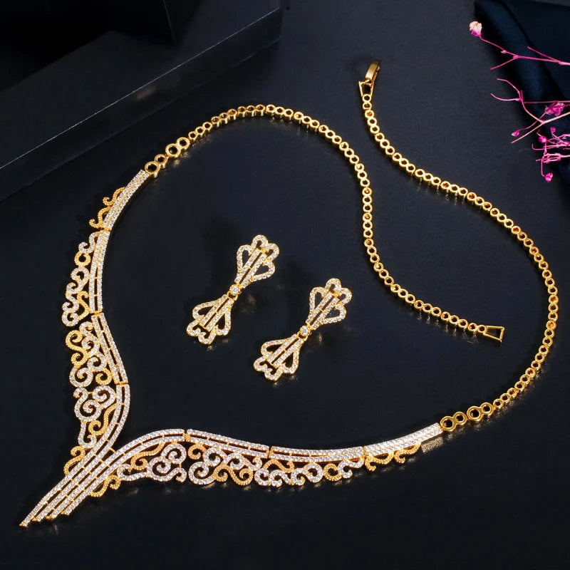 Gold-tone bridal jewelry set with a sparkling scrollwork necklace and matching drop earrings