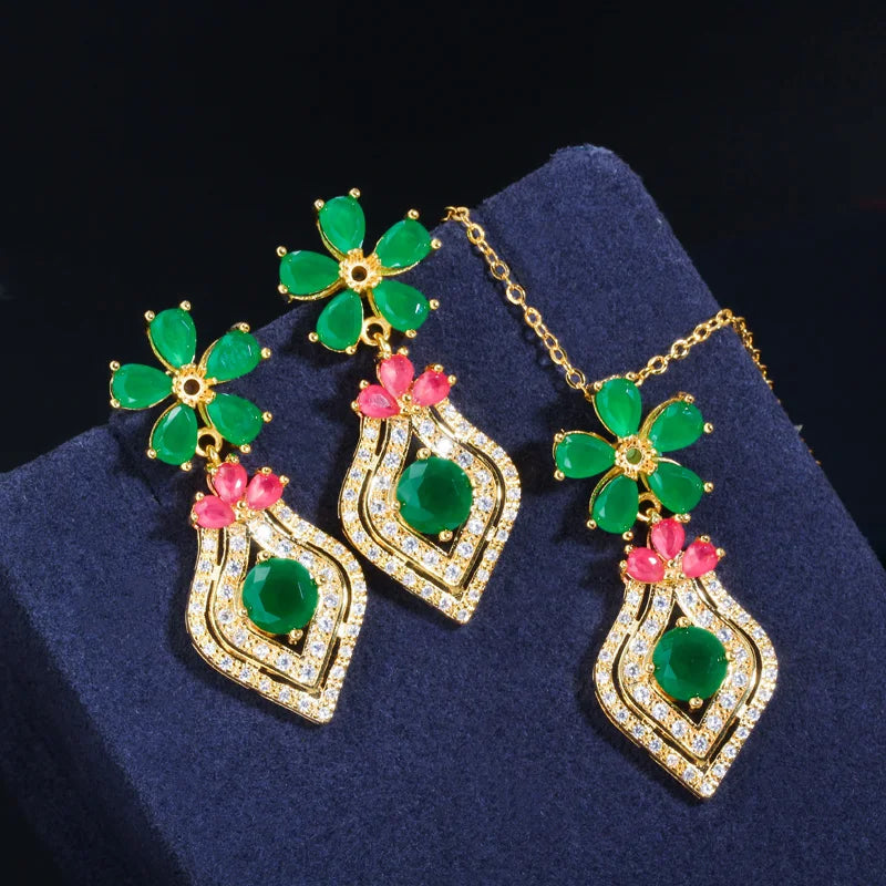 Gold-tone necklace and earrings with green floral stones and pink-accented drop pendants