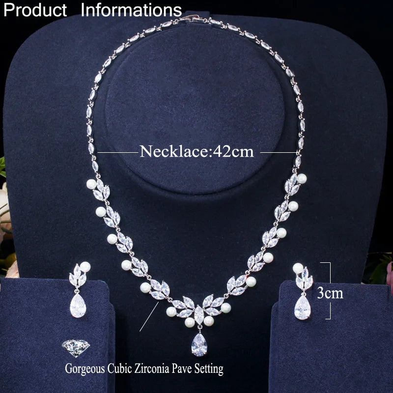 Necklace and earrings set with cubic zirconia leaf motifs and pearl bead details