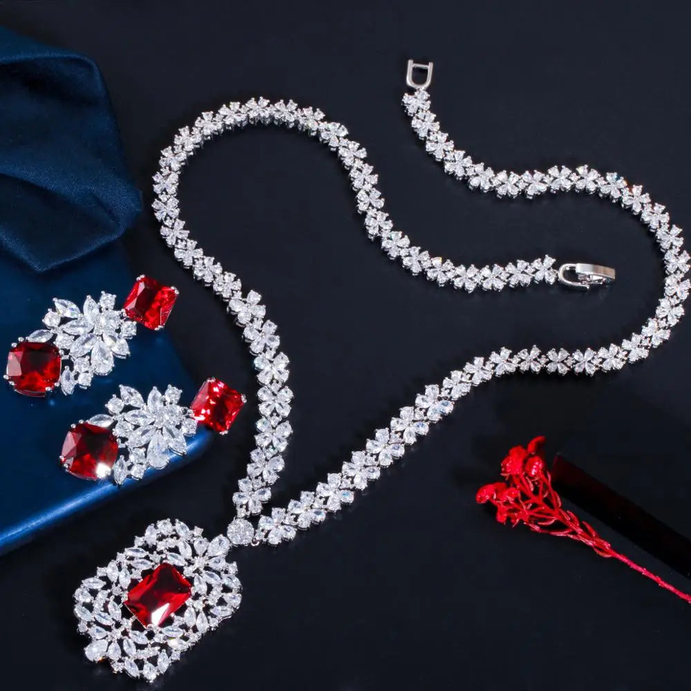 Cubic zirconia flower necklace set with red accent stones and matching earrings