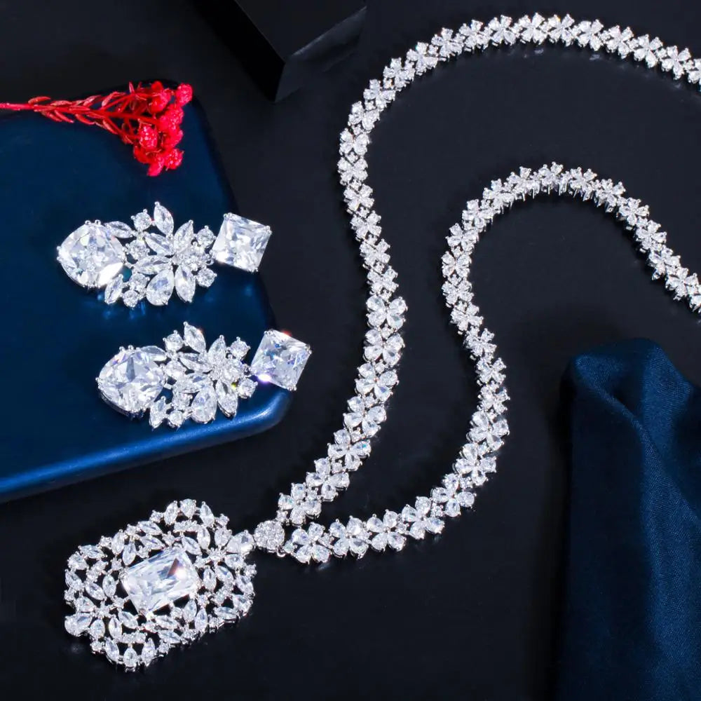 Cubic zirconia flower necklace set with matching earrings and red cord