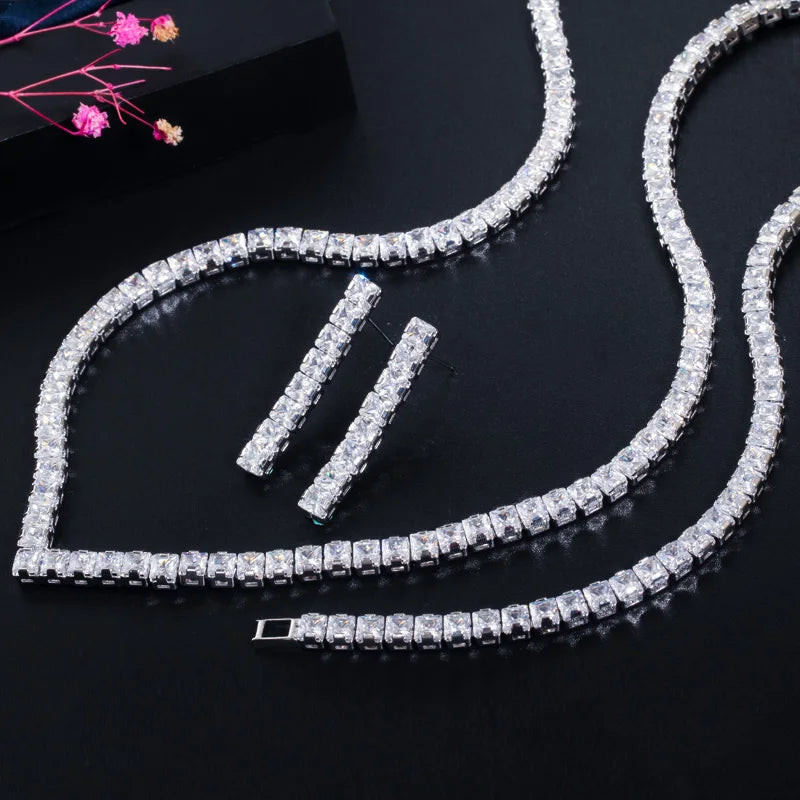 Close view of silver-tone square-stone tennis necklace, bracelet and drop earrings