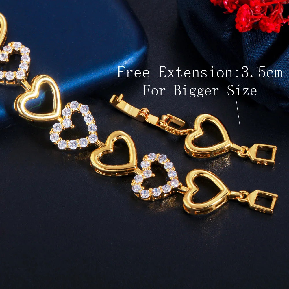 Close-up of gold-tone heart links and clear stone accents on the jewelry set