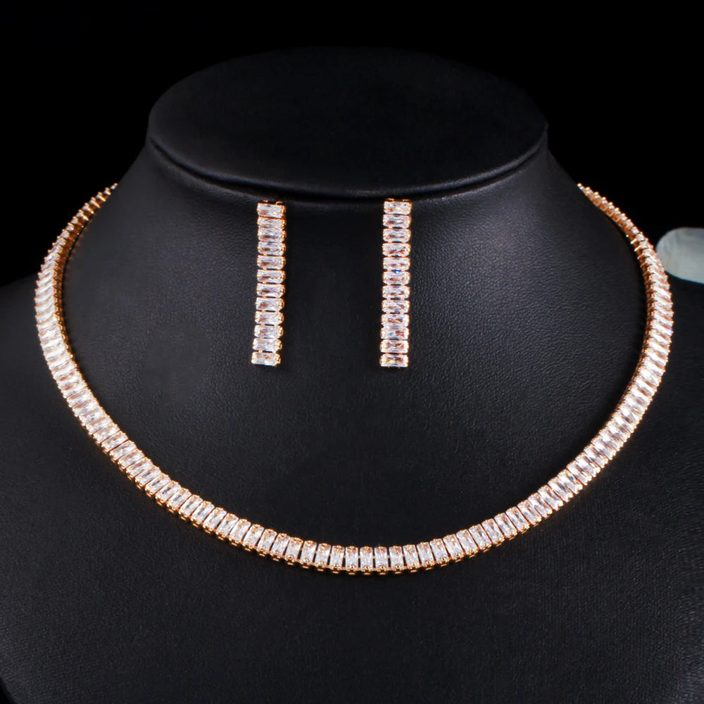 Gold-tone necklace and drop earrings with rows of rectangular clear stones