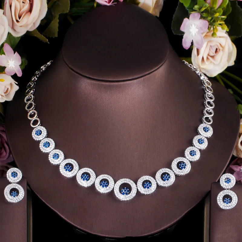 Silver-tone necklace and earrings with round blue stones and sparkling circular halos
