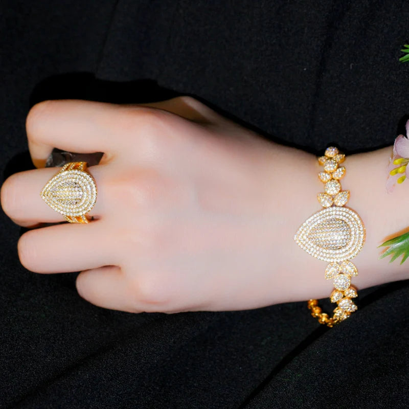 Gold-tone teardrop zircon ring and bracelet shown on a hand