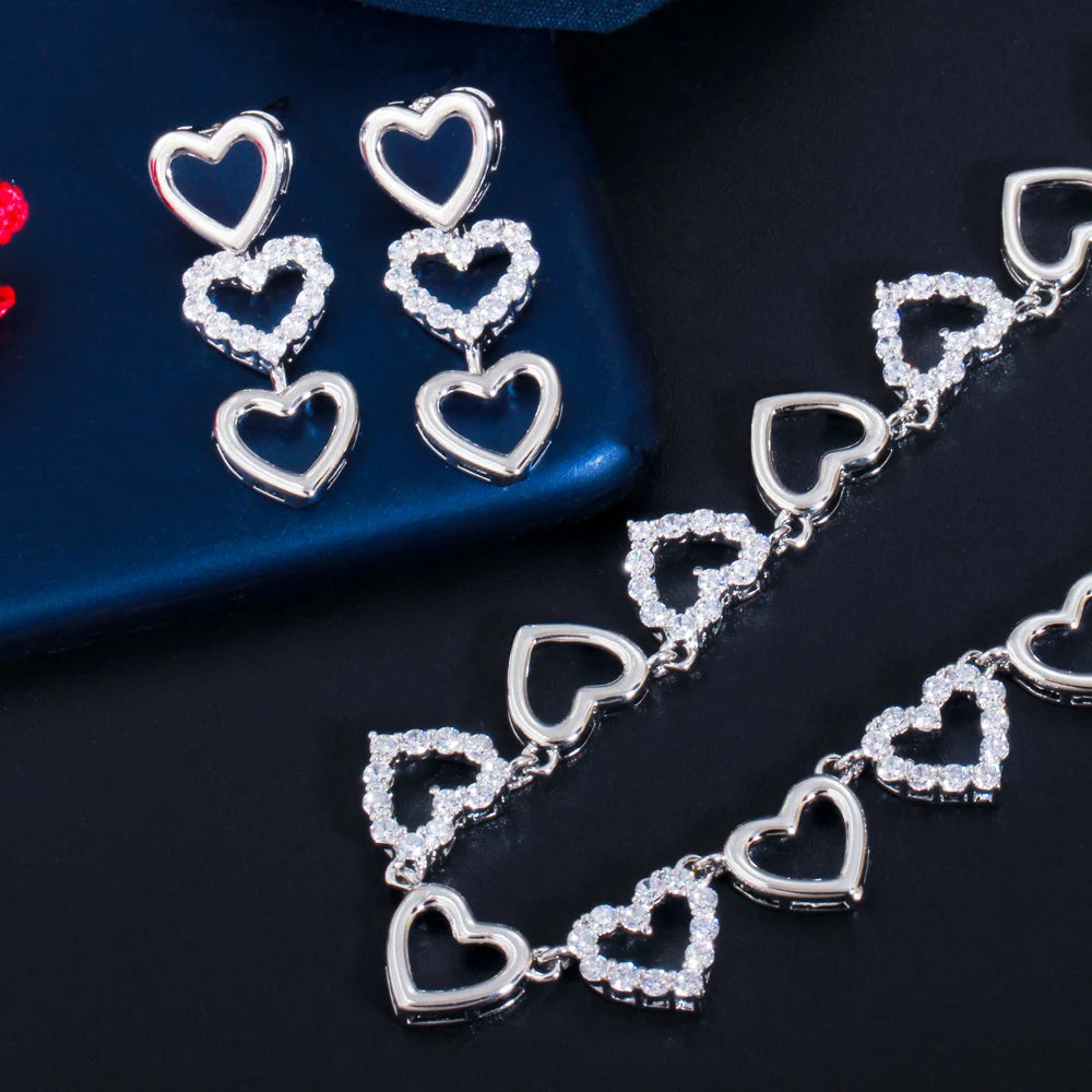 Silver-tone heart necklace and matching dangling earrings with clear stones