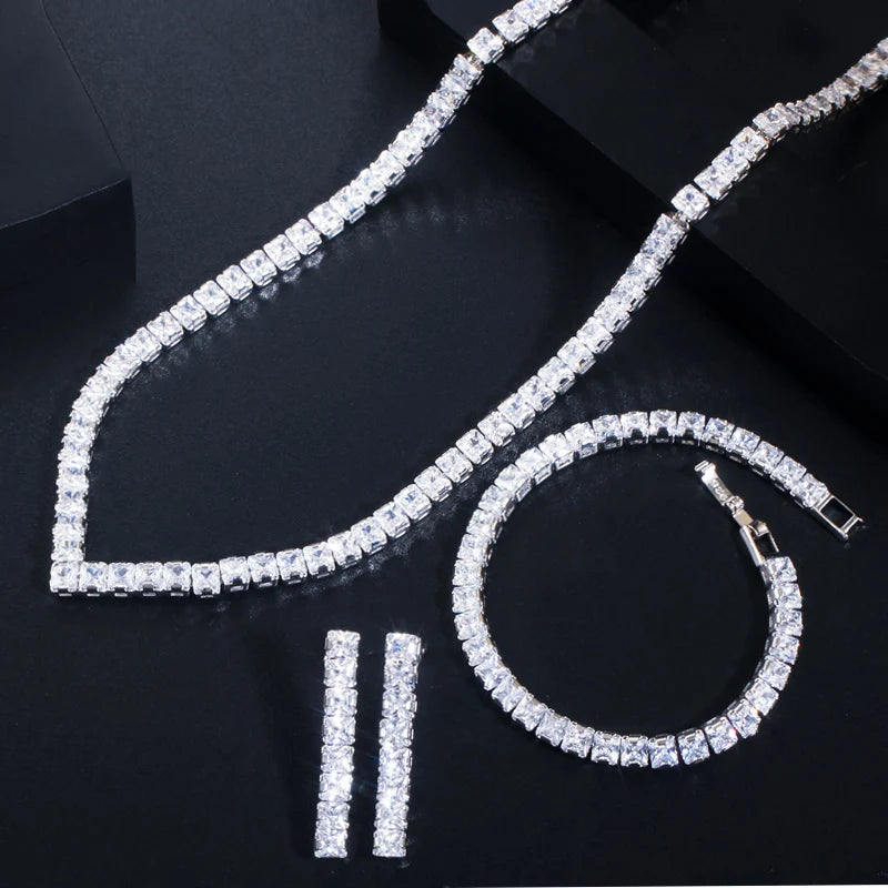 Silver cubic zirconia jewelry set with serpentine necklace, hoop earrings, and stud earrings