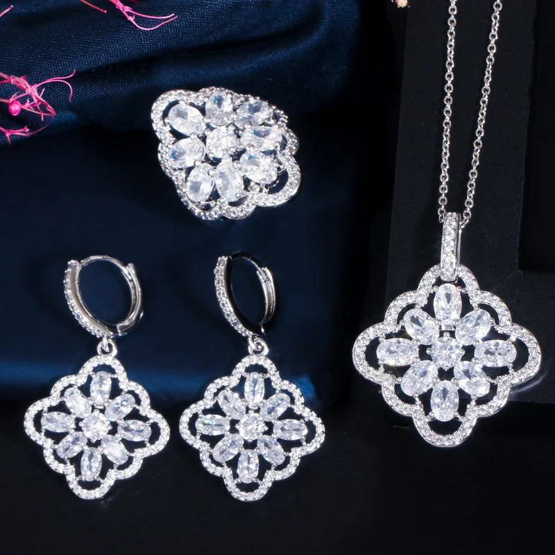 Three-piece silver-tone jewelry set with clear zircon floral pendant, drop earrings, and ring