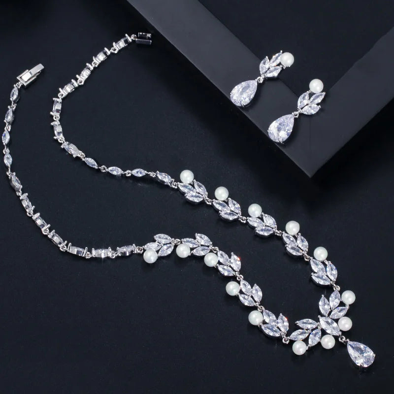 Jewelry set with cubic zirconia leaf necklace, pearl accents, and dangling teardrop earrings