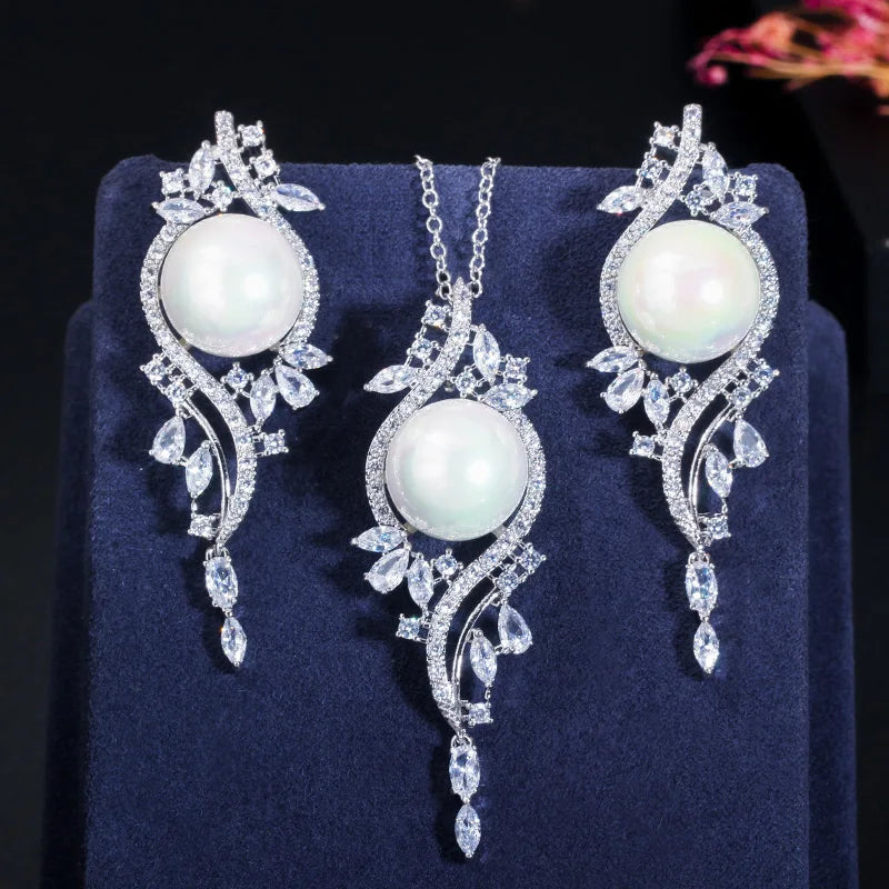 Front view of white imitation pearl jewelry set with clear zirconia leaf accents