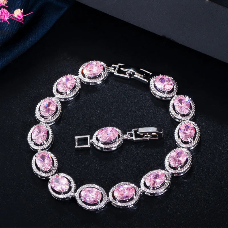 Oval pink CZ bracelet with round halo stones and silver-tone clasp