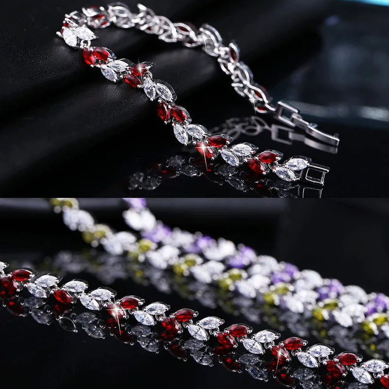 Close-up of a silver-tone bracelet with red and clear marquise-cut stones