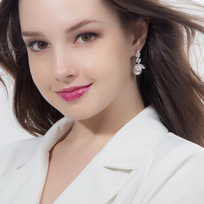 Crystal leaf and pearl drop earring worn on a model
