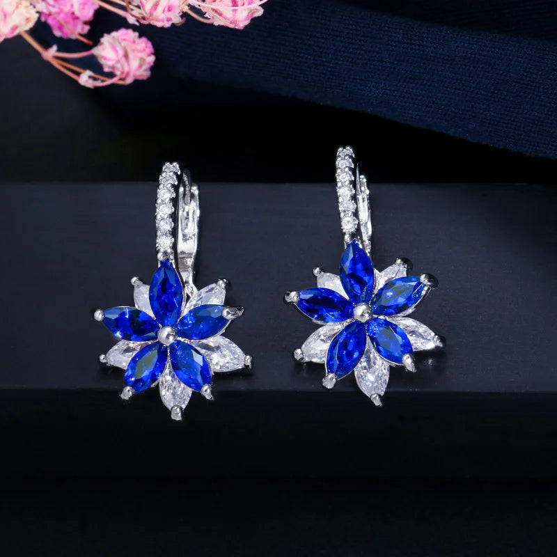 Pair of blue flower earrings with clear gemstone petals and stone-set hoops