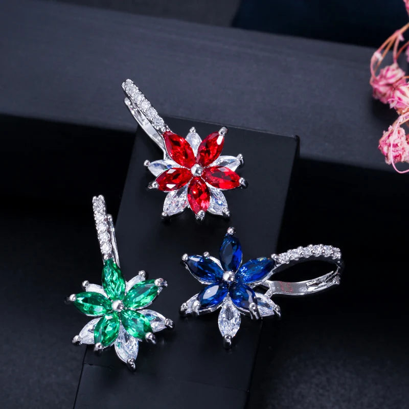 Flower stud earrings with red, green, and blue gemstone petals and clear stones