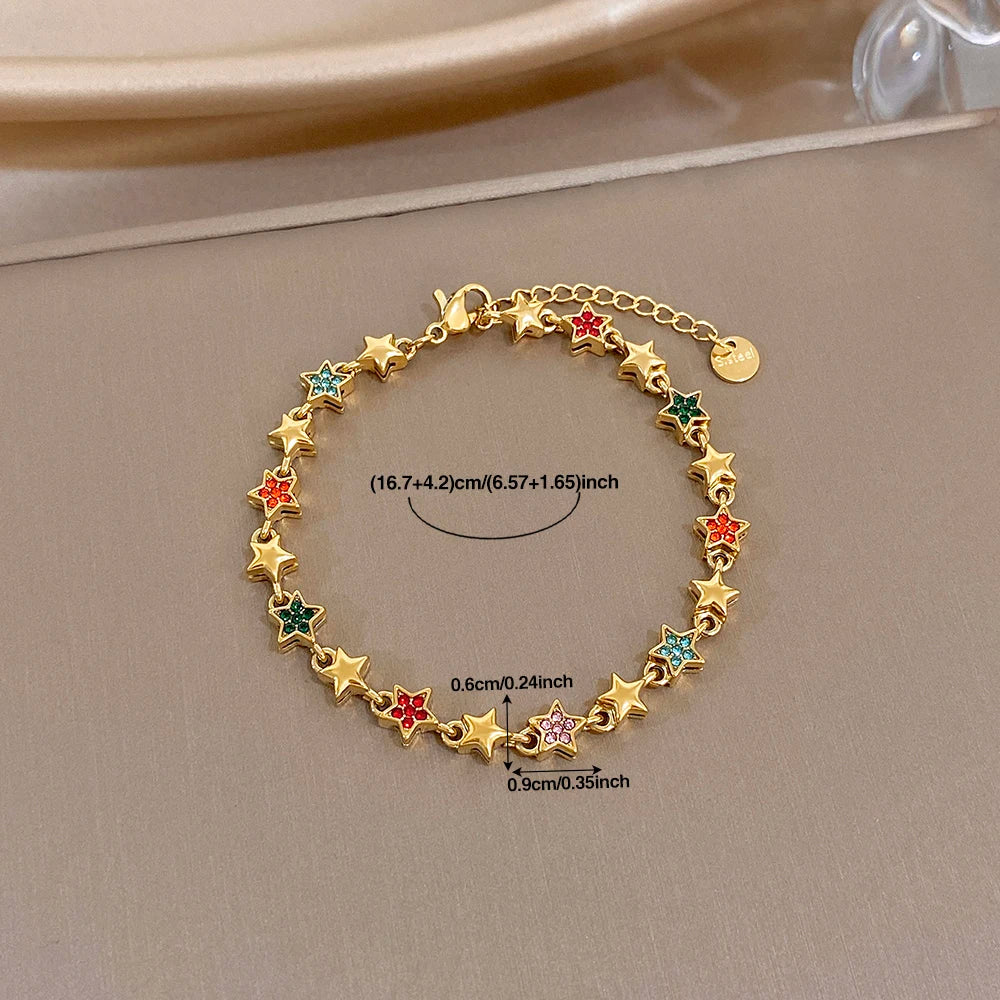 Gold-tone star charm bracelet with multicolor gem stars and small round extender clasp
