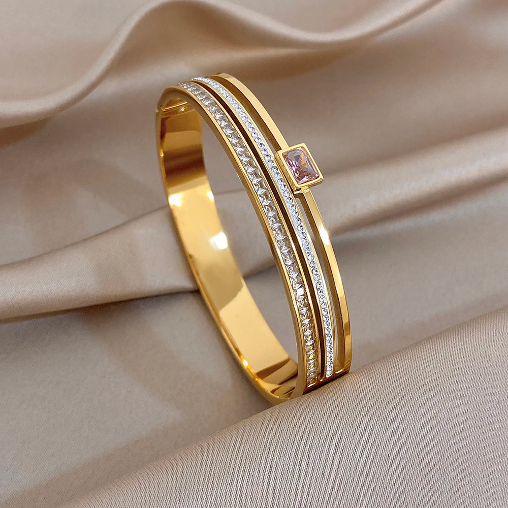 Gold-plated rhinestone cuff bangle with pink square center stone, slim design