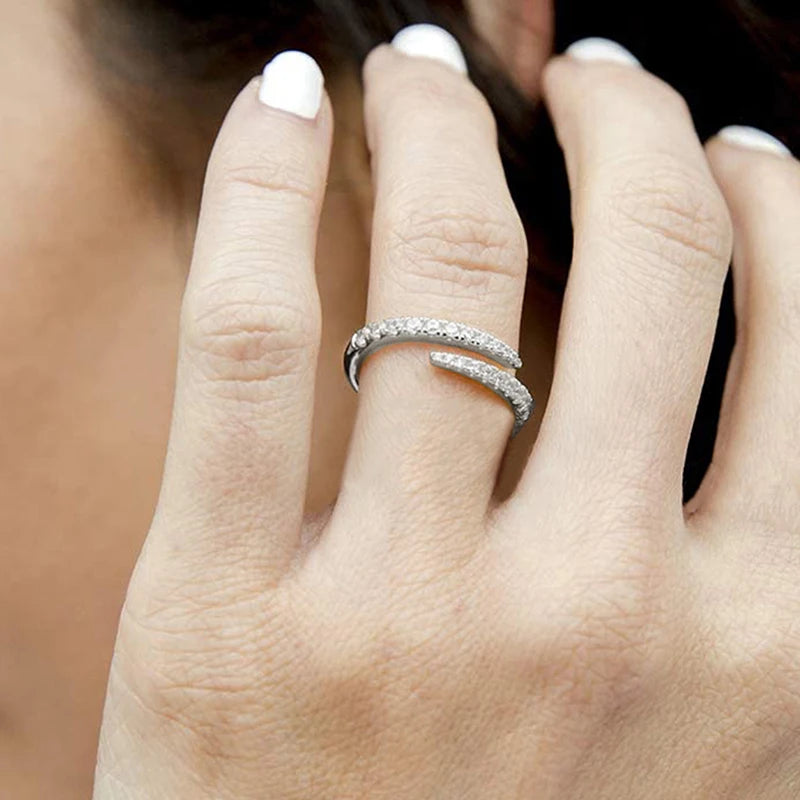 Adjustable open zirconia ring on hand, silver tone with two rows of round clear stones