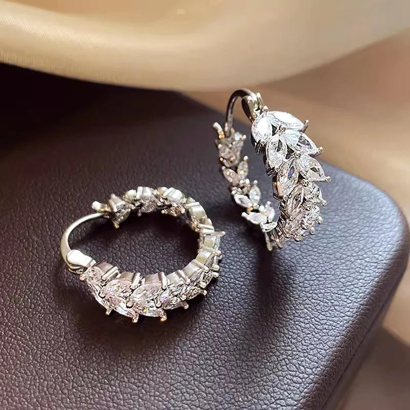 Silver cubic zirconia marquise hoop earrings with clustered stones, curved silhouette