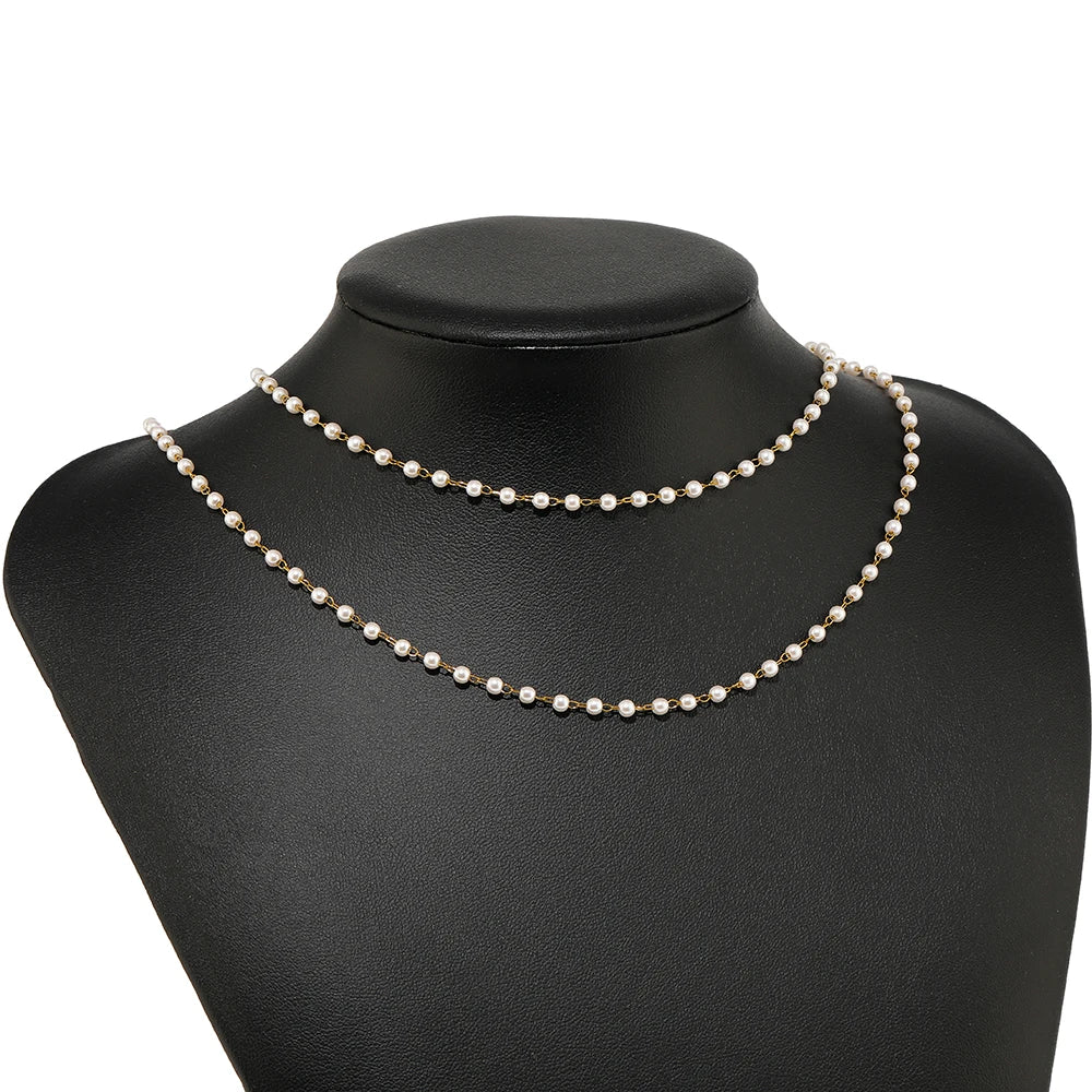 White imitation pearl necklace chain on black display bust, mixed gold-tone and silver-tone links