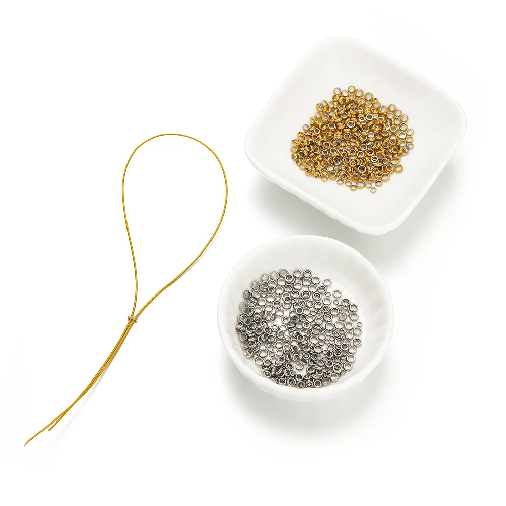 Gold and silver spacer bead stoppers in small white dishes, round crimp ends