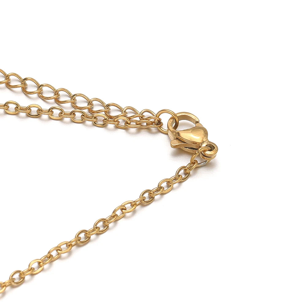 Gold-tone flat link extension chain with lobster clasp and connector ring detail