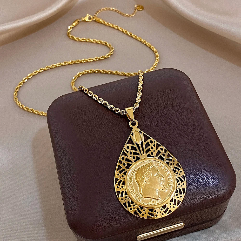Gold-plated stainless steel necklace with teardrop filigree coin pendant and geometric border