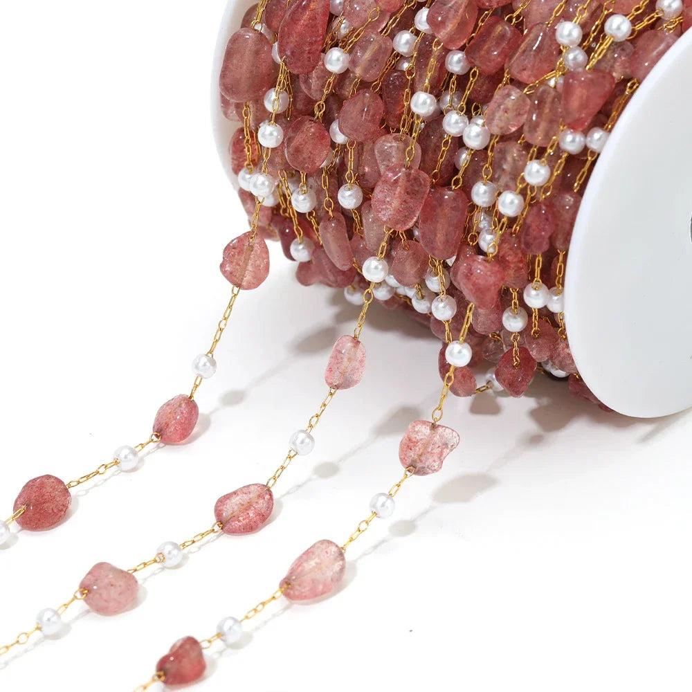 Irregular stone bead chain with pearl accents on gold-toned links, pink and rose beads