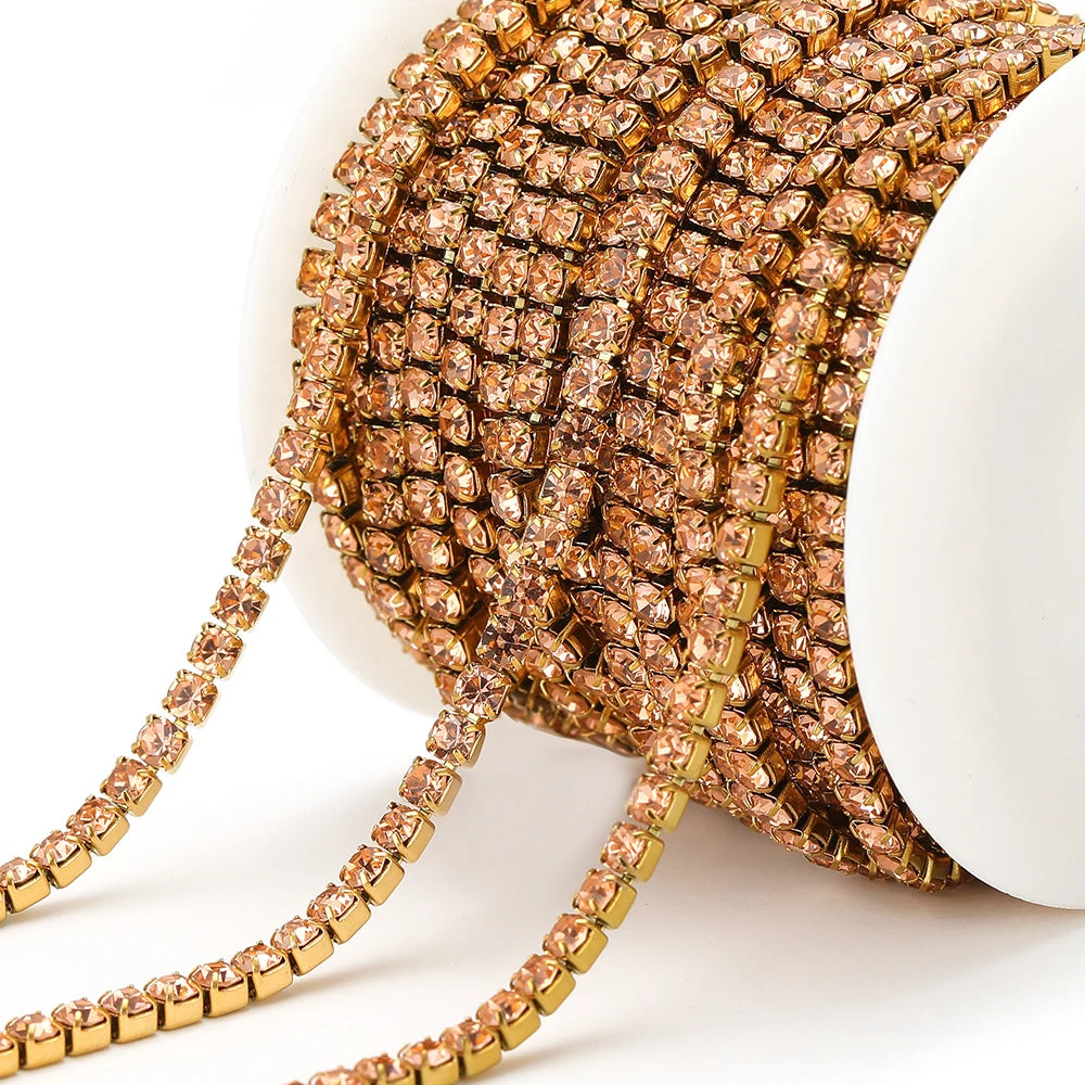 Rose-gold rhinestone chain tassel with square crystal links on white spool