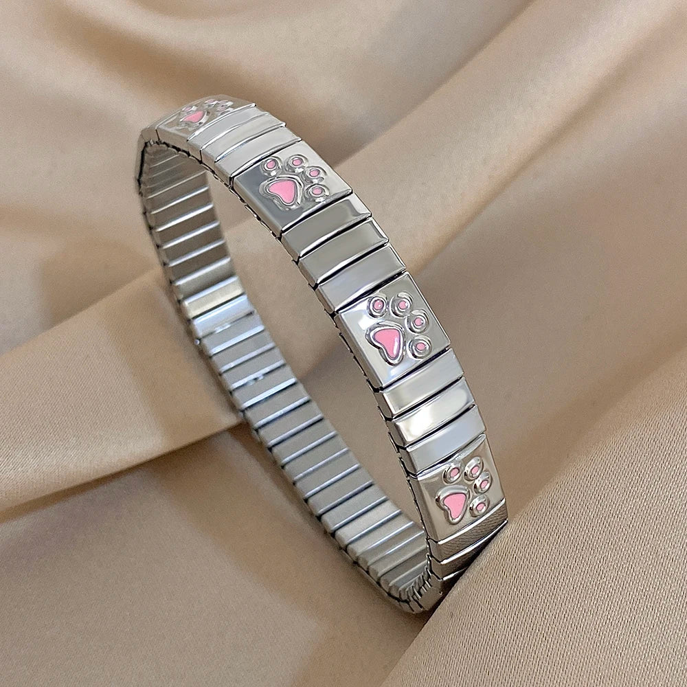 Silver enamel paw print link bracelet bangle with pink paw charms, elastic wristband.