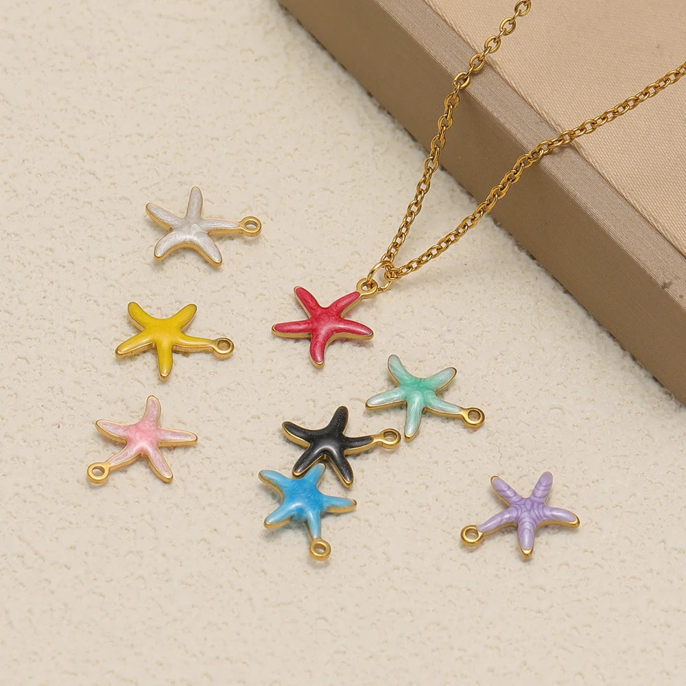 Assorted starfish pendant charms in pastel and dark colors with gold-tone loops