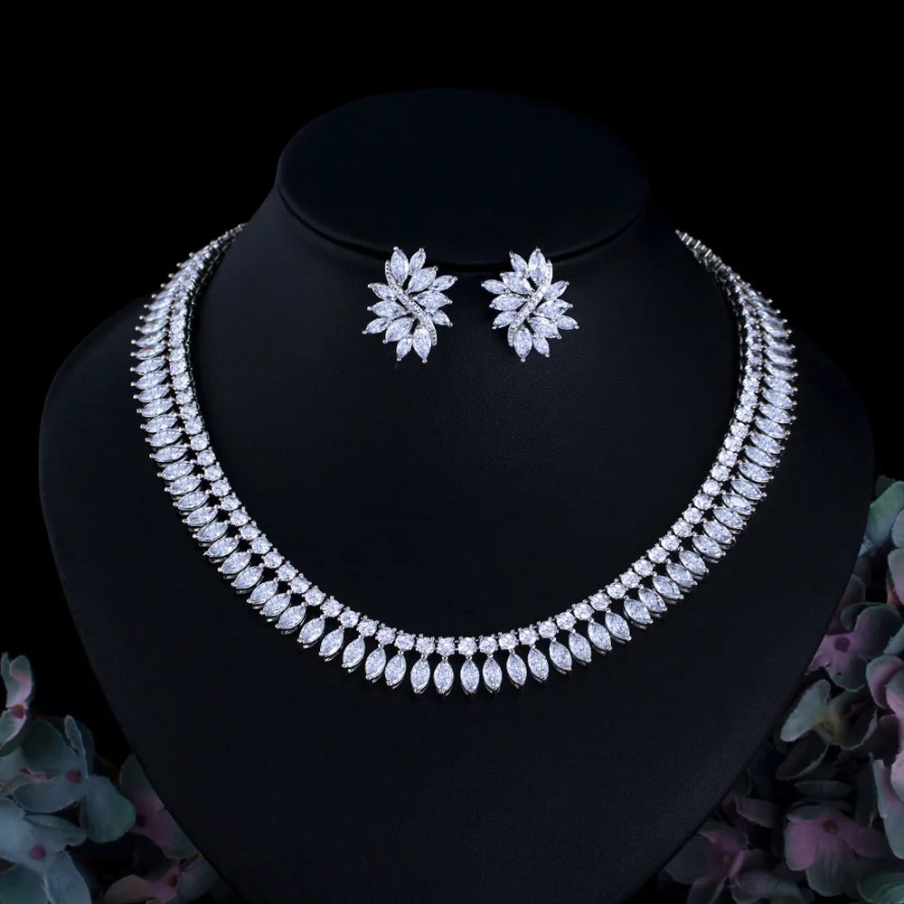 Leaf-shaped cubic zirconia necklace and matching floral stud earrings on a display bust