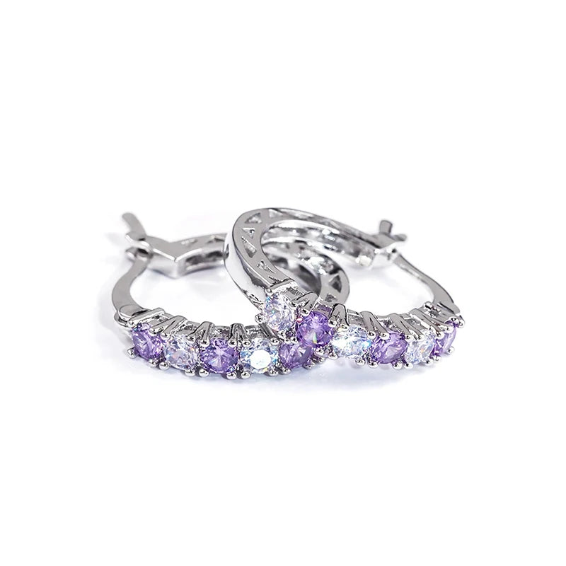 Silver circle hoop earrings with purple and clear gemstone row