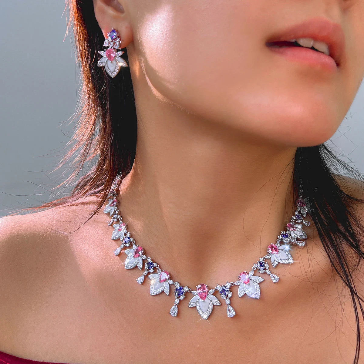 Multicolor cubic zirconia necklace with leaf and bow charms, matching drop earrings