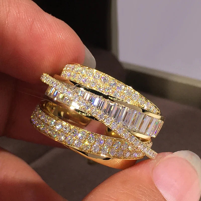 Gold multi-band crossover ring with clear CZ stones and baguette accents