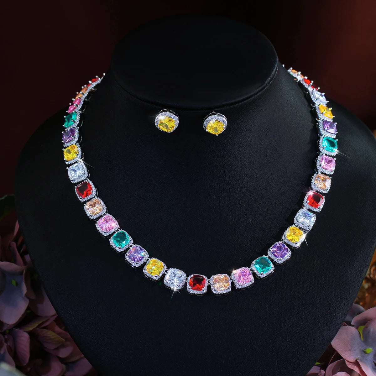 Multicolor square zirconia necklace and matching round stud earrings on a display bust