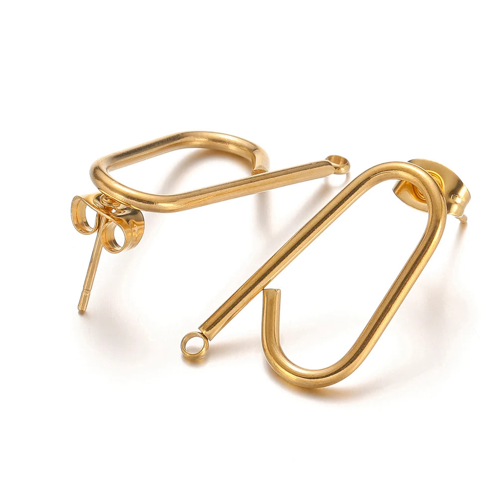 Gold long stick ear wire hooks connectors, close-up of two curved wire pairs