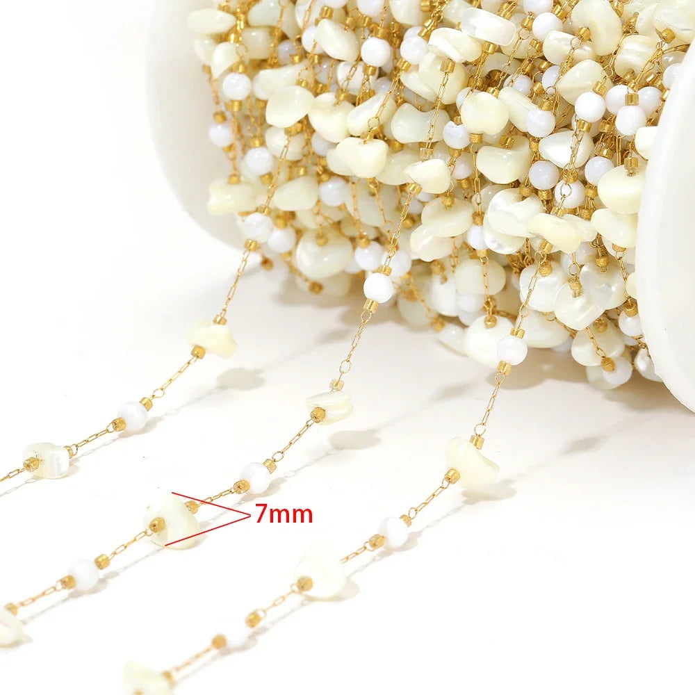 Shell bead chain with small white shell drops on gold-tone link rows (7mm marked)
