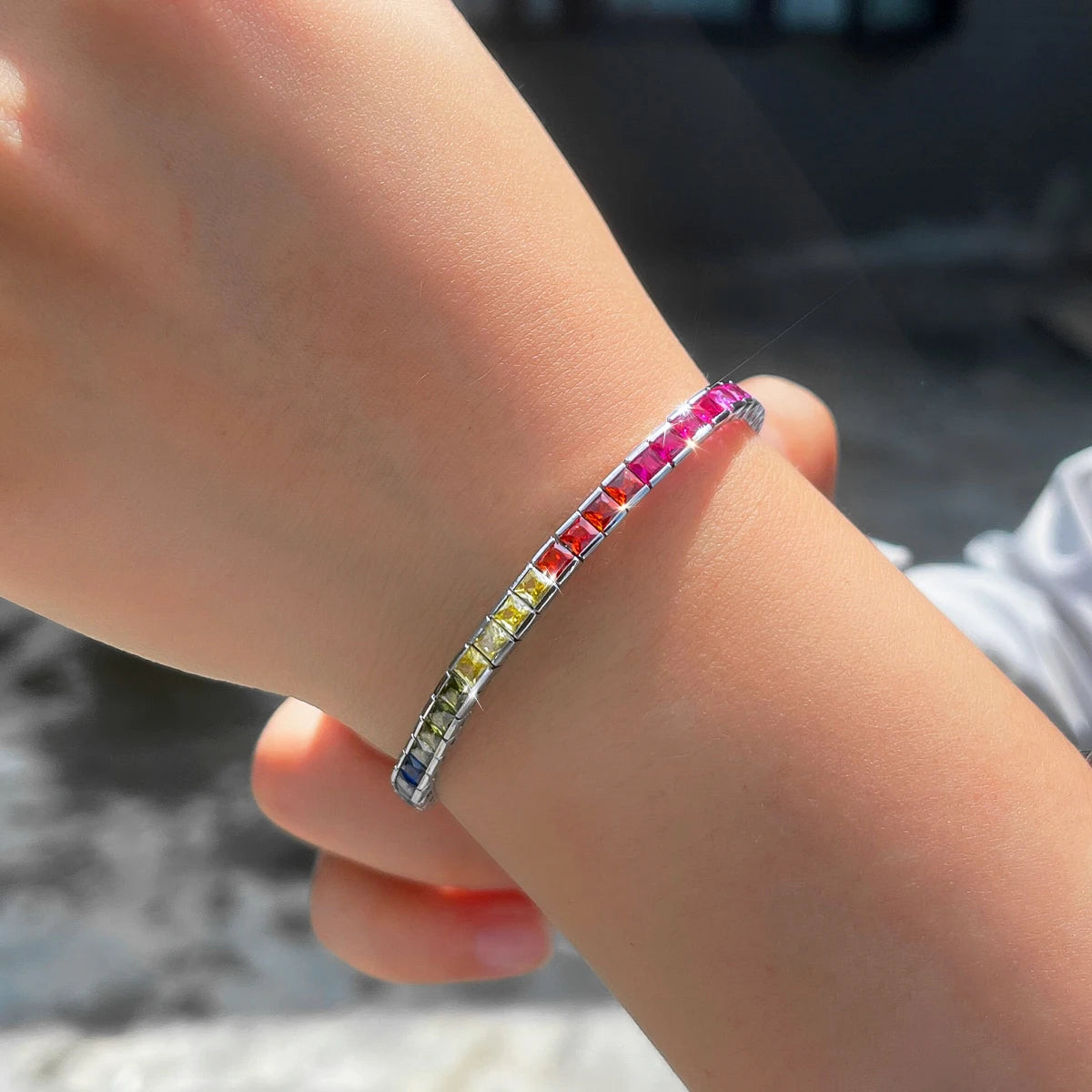 Single rainbow square-cut zirconia bracelet worn on wrist