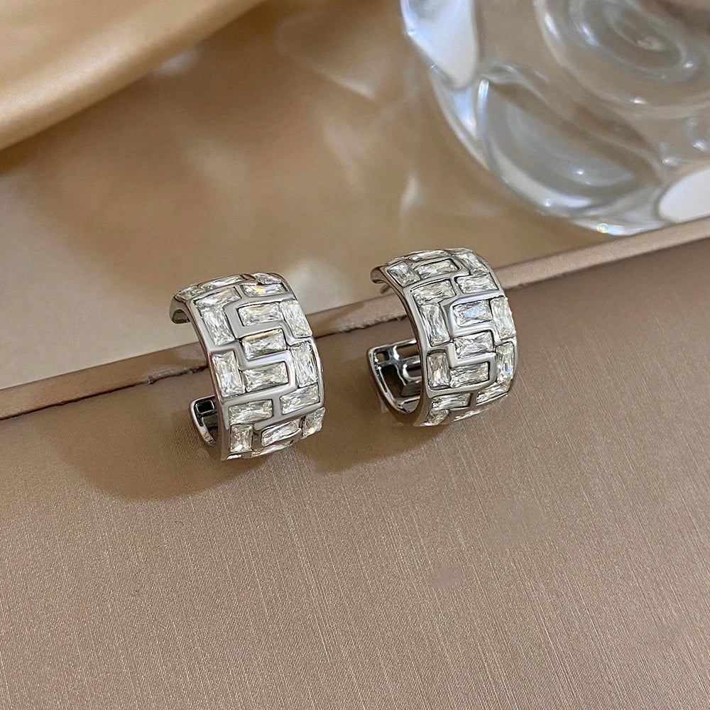 Silver-tone geometric hoop earrings set with clear square-cut stones