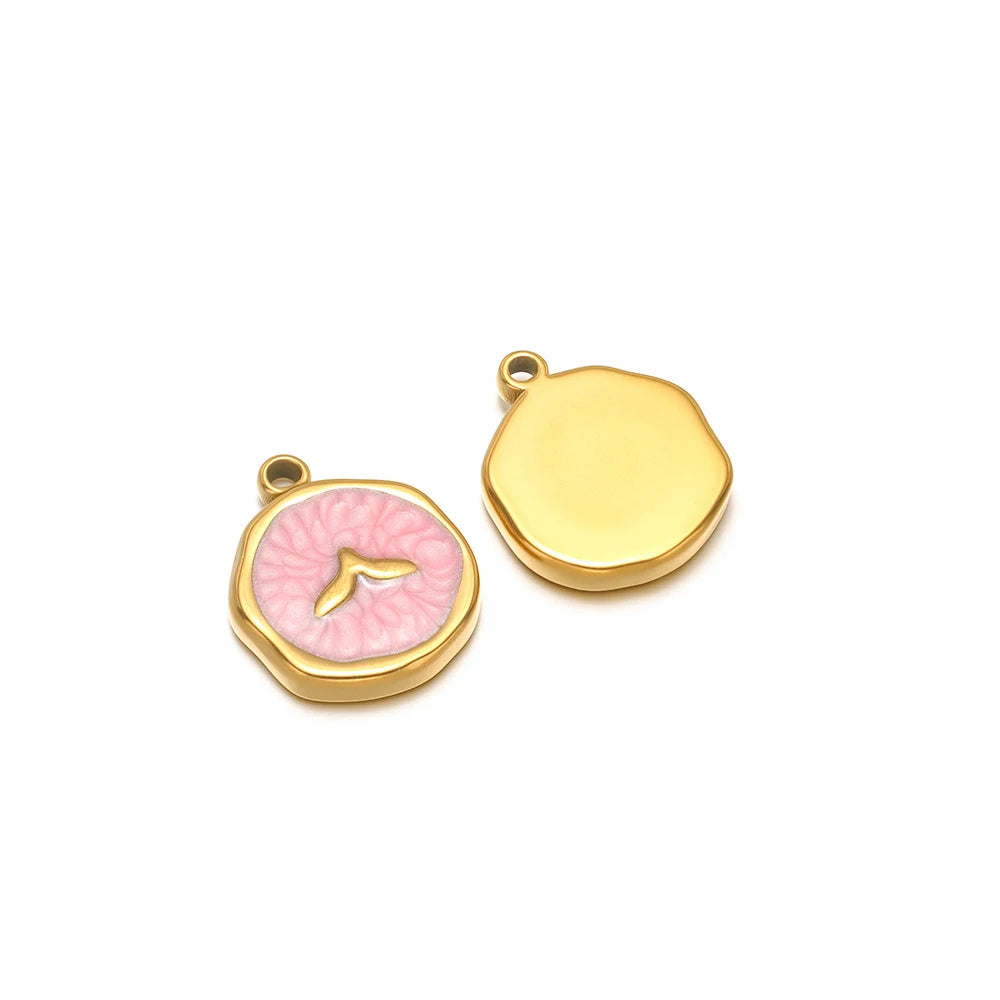 Pair of enamel ocean charms: yellow shell charm and pink seashell charm with gold fish