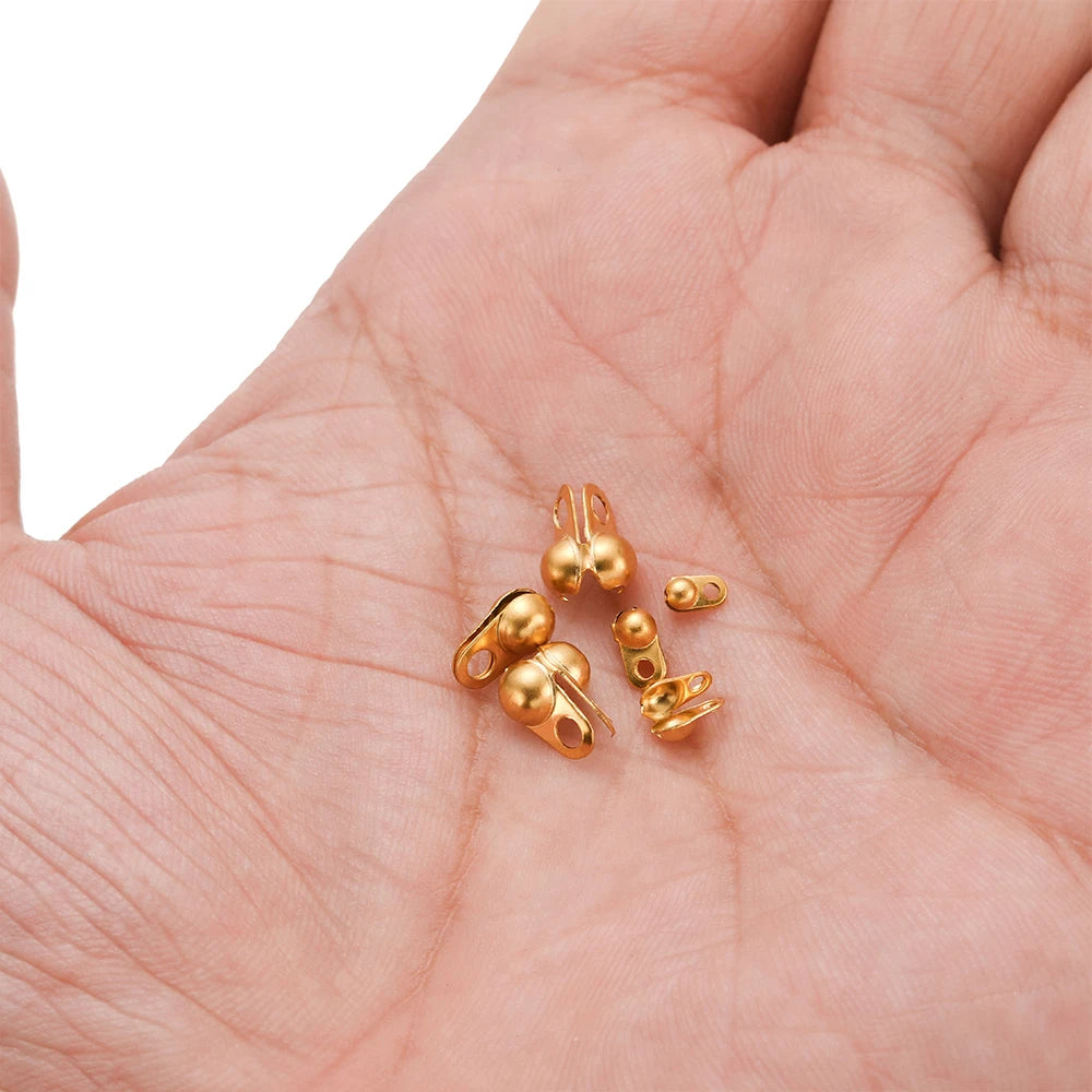 Gold tone end crimp bead hook connectors in hand, small metal clasp findings