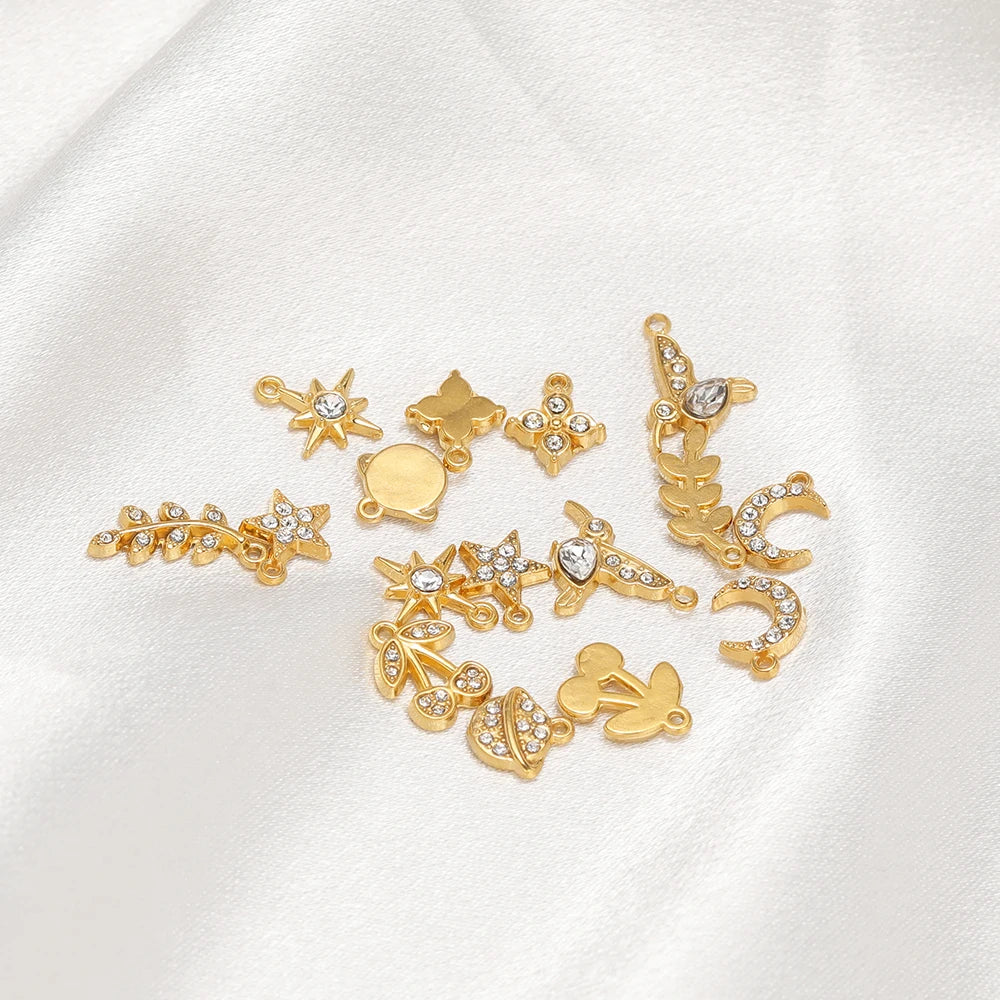 Assorted gold-tone charm pendants with rhinestones and hanging loops for DIY jewelry