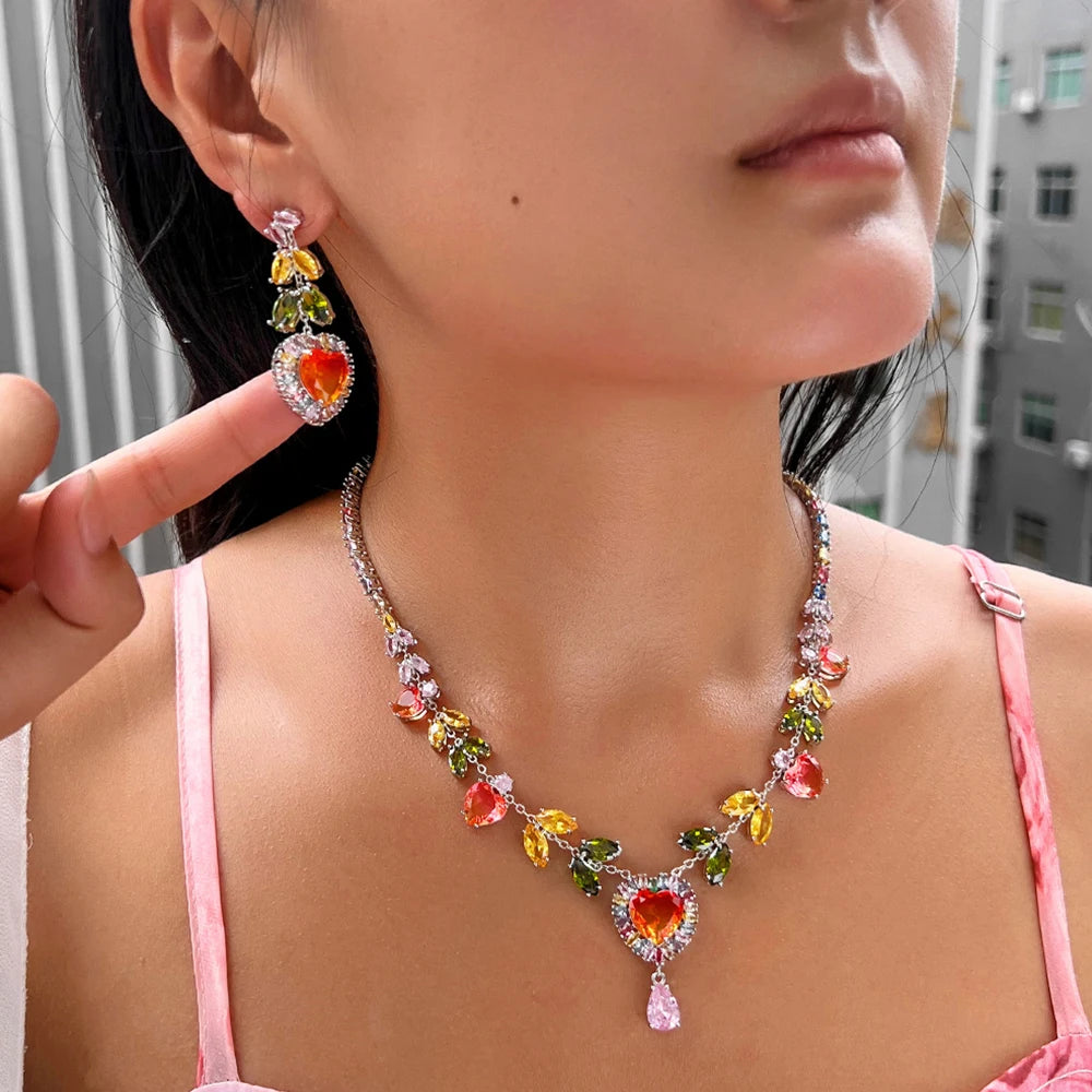 Heart zircon necklace and matching earring worn, with red, yellow, green, and pink stones