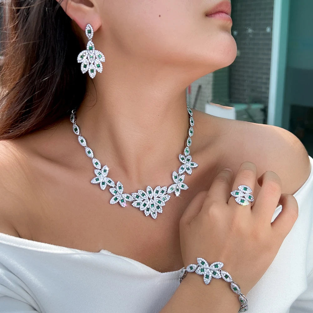 Green zirconia floral necklace with drop earrings, ring, and bracelet on model